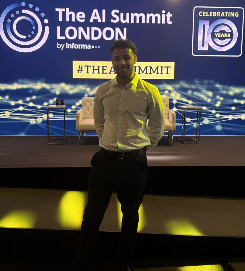 Joshua standing alone in front of the stage at The AI Summit London