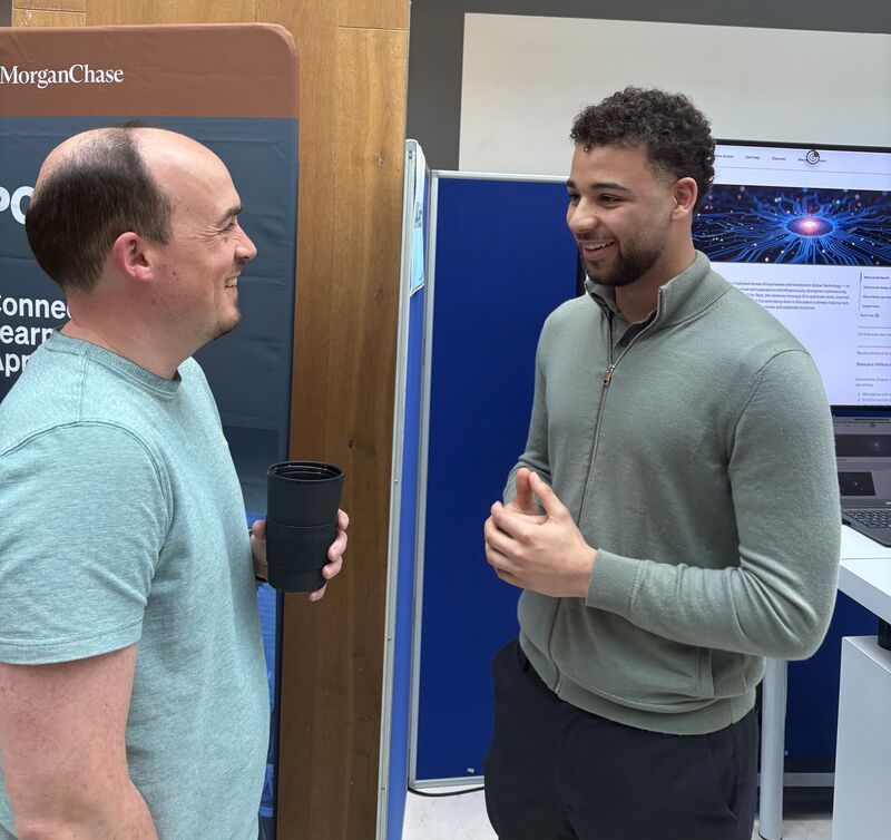 Joshua discussing a technology project at an event